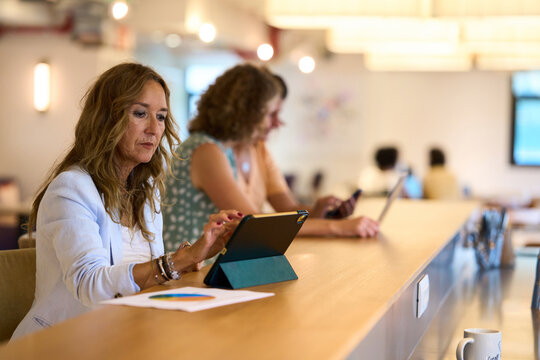 Businesswoman working on tablet in coworking office