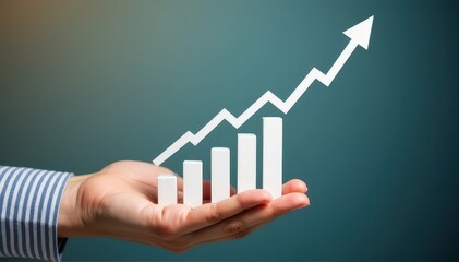 A hand holding a rising bar chart with an upward arrow, symbolizing business growth, revenue increase, and improved performance.