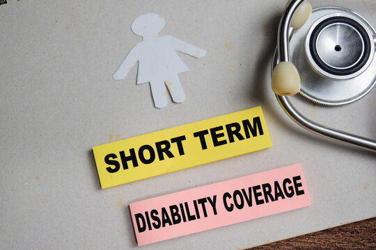 Concept of short term disability coverage write on sticky notes isolated on Wooden Table.