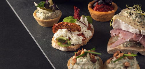 Gourmet canape selection with cheese and sundried tomato