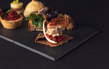 Gourmet platter of assorted creative appetizers on slate