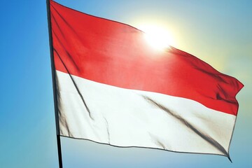 Indonesia national flag waving in sunlight close-up – Indonesian red and white horizontal bicolor banner patriotic Southeast Asian country symbol background blue sky bright sunny day
