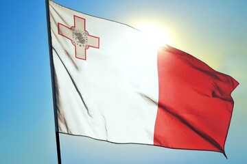 Malta national flag waving in sunlight close-up &ndash; Maltese white and red vertical stripes banner with George Cross emblem patriotic European island country background blue sky sunny day