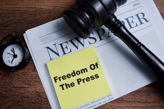 Concept of freedom of the press write on sticky notes isolated on Wooden Table. - Powered by Adobe