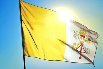 Vatican City national flag waving in sunlight close-up &ndash; Holy See yellow and white banner with papal tiara crossed keys symbol of Catholic Church religion patriotic background blue sky sunny day