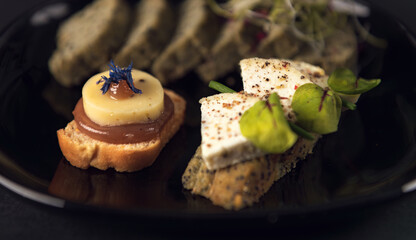 Large gourmet catering table with mini burgers and assorted canapés
