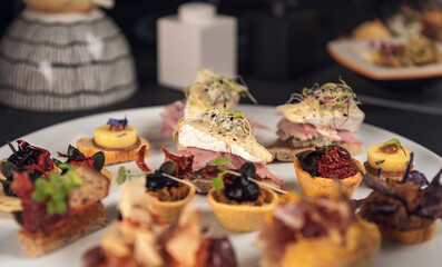 Mini burgers and gourmet appetizers on catering table