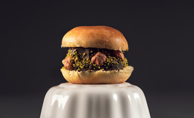 Blackberry and berry compote dessert in white cupGourmet dessert burger with hazelnut and pistachio crust