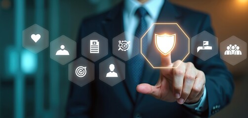 Businessman in dark suit, tie points at glowing shield icon on virtual screen. Surrounding interactive hexagons feature health, people, document records, target, process audit symbols. Highlights