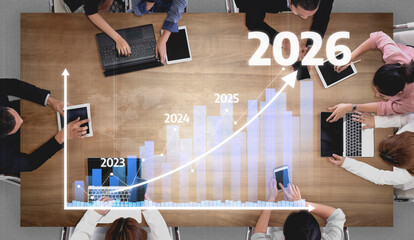 A diverse team of professionals engages in a strategic meeting, analyzing growth data and...