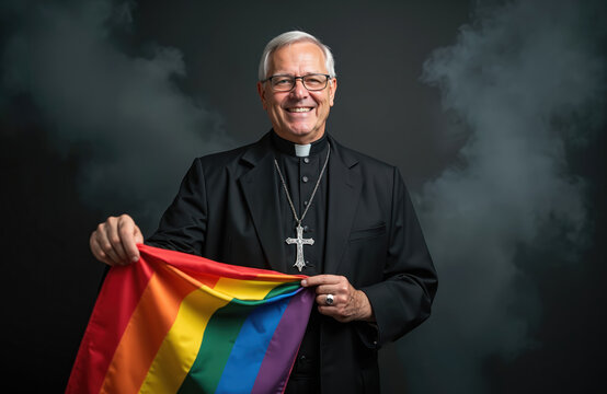 Smiling priest holds an LGBT pride flag. He wears a cassock with a silver cross. The clergyman stands in a studio on a smoky black backdrop supporting queer rights and inclusivity.