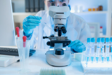 A chemistry researcher in a laboratory surrounded by scientific equipment and test tubes, representing innovation, scientific development, and modern medical research environment.