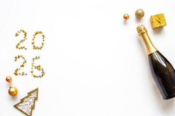 Christmas decoration flat lay with bottle of champagne, top view