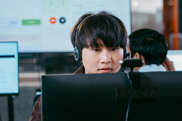 Remote Assistance, Consulting in Call center office, Male Technical, Customer care support white headset Talking to Client, Helping, Advice and Providing CRM Support looking at computer screen at desk