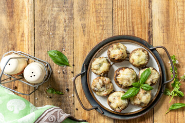 Stuffed mushrooms baked with cheese on rustic background. Top view.