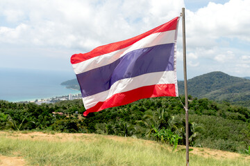 The Thai flag flutters against a forest backdrop. A symbol of Thai identity, culture, and patriotism