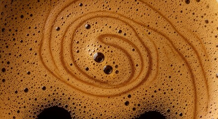 Close-up of Brown Coffee Foam Swirl with Bubbles on Surface
