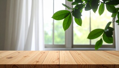 Sunlit wooden tabletop with open window, white curtains, and green leaves outside.