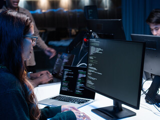 Close-up of Young Female computer programmer working on desktop computer, writing code, developing app, Ai prompt project sit at desk in tech company office. Professional Programmer Working on Coding.