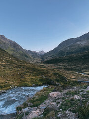 Mountain valley stream flowing through natural landscape