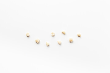 Many human teeth crown for dental implantation on white background. Professional Dentist tools, top view