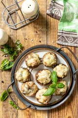 Stuffed mushrooms baked with cheese on rustic background. Top view.