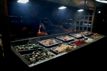A variety of delicious clams, crab, shrimp, squid at street food carts in Indonesia