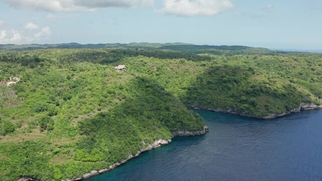 Stunning aerial drone view of Amok Sunset, a popular sunset point perched high on a cliff in Nusa Penida, Bali, Indonesia.