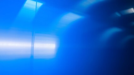 Blue metallic surface with geometric reflections, creating an abstract industrial backdrop.