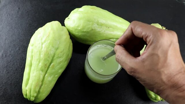Raw chayote squash and its soup in a cup