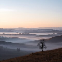 Obraz premium Serene Morning Landscape with Fog Rolling Over Hills