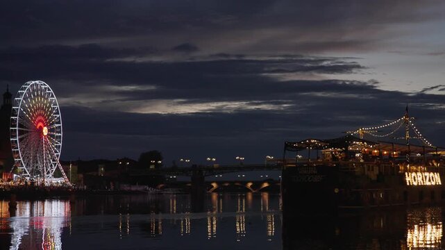 View of Garonne dock and ferris wheel at night, Toulouse France