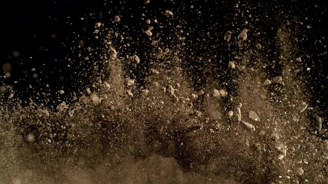 Super Slow Motion Shot of Exploding Soil with Rocks Camera at 1000fps.