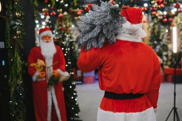 Santa claus costume carrying christmas tree bringing holiday spirit