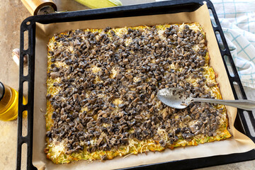 Step-by-step cooking recipe zucchini roll with mushroom filling.