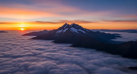 Breathtaking mountain landscape with a fiery sunset over the valley and high peaks under a dramatic, cloudy sky