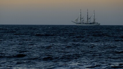 beautiful old sailboat in the evening sea