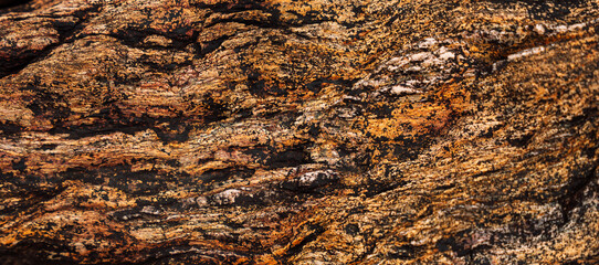 Close-up of layered sedimentary rock surface with orange tones. High quality photo