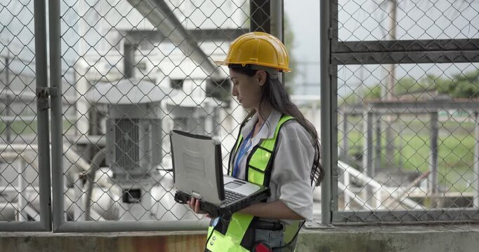 A female field analyst performs inspection and data collection at a pumping station. Technical fieldwork, quality control, and carbon footprint monitoring in utility infrastructure management.

