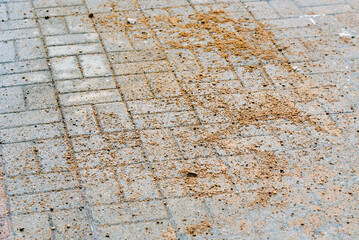 Closeup of sand on paving slabs used for road traction control during icy winter weather ensuring...
