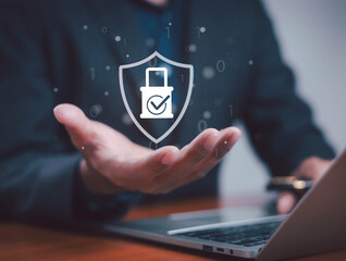Businessman showing digital security shield with lock and check mark icon, representing cybersecurity, data protection, privacy, online safety, and information technology concept for secure business.