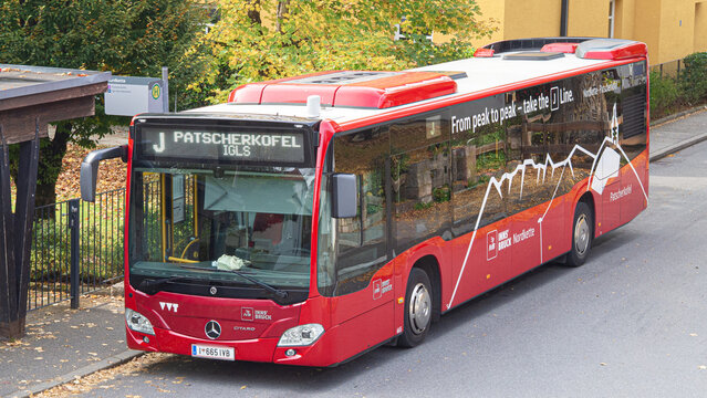 Innsbruck city bus with Nordkette branding at stop in autumn perfect for promo of Austrian public transportation Innsbruck, Austria 18 October 2025