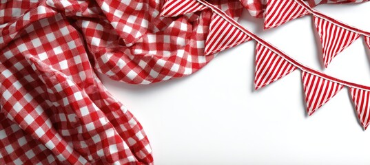 Red and white checkered fabric draped with festive striped triangle banners on a white background