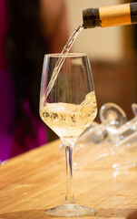 Close up of pouring white wine into glass