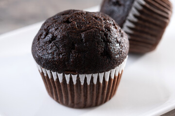 Homemade chocolate muffins on wooden table
