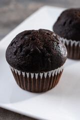 Homemade chocolate muffins on wooden table