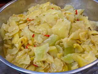 Pickled cabbage, also known by various regional names such as sauerkraut or Asian pickled cabbage. in a large bowl 