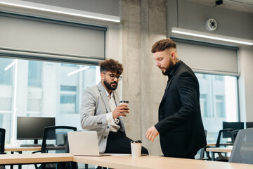 Business colleagues collaborating on an informal office discussion