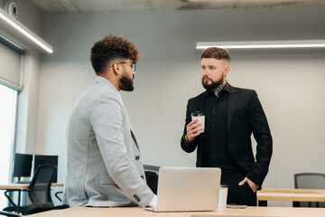 Diverse business partners discussing project in modern office