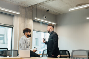 Diverse business professionals discussing strategy during coffee break